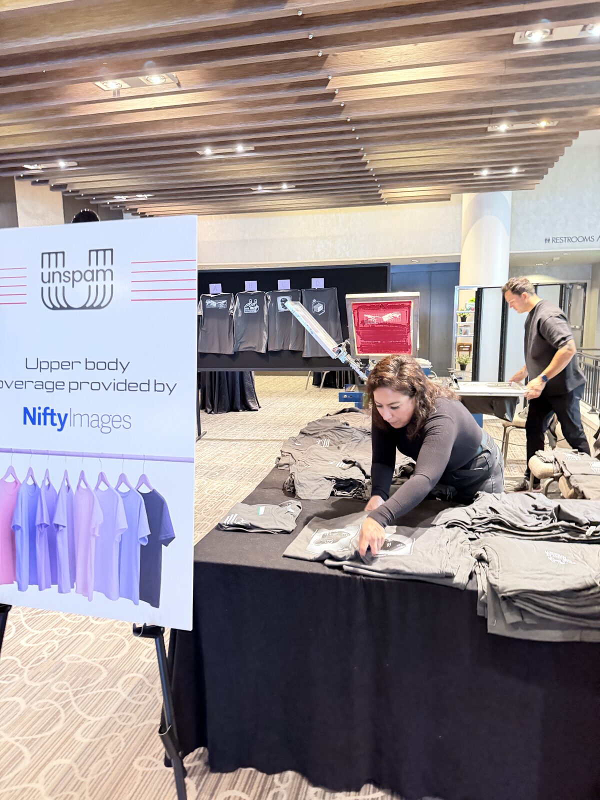 Styled merch table with custom shirts arranged for a wedding celebration