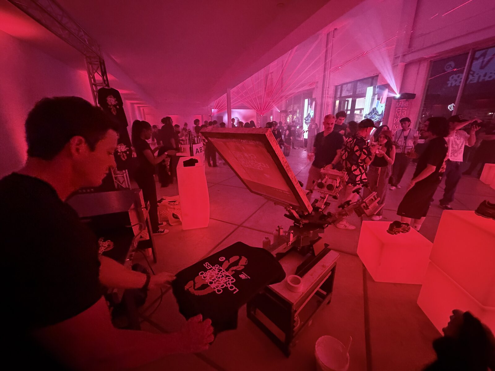 Wedding guest smiling with a custom tee just printed at the t-shirt bar